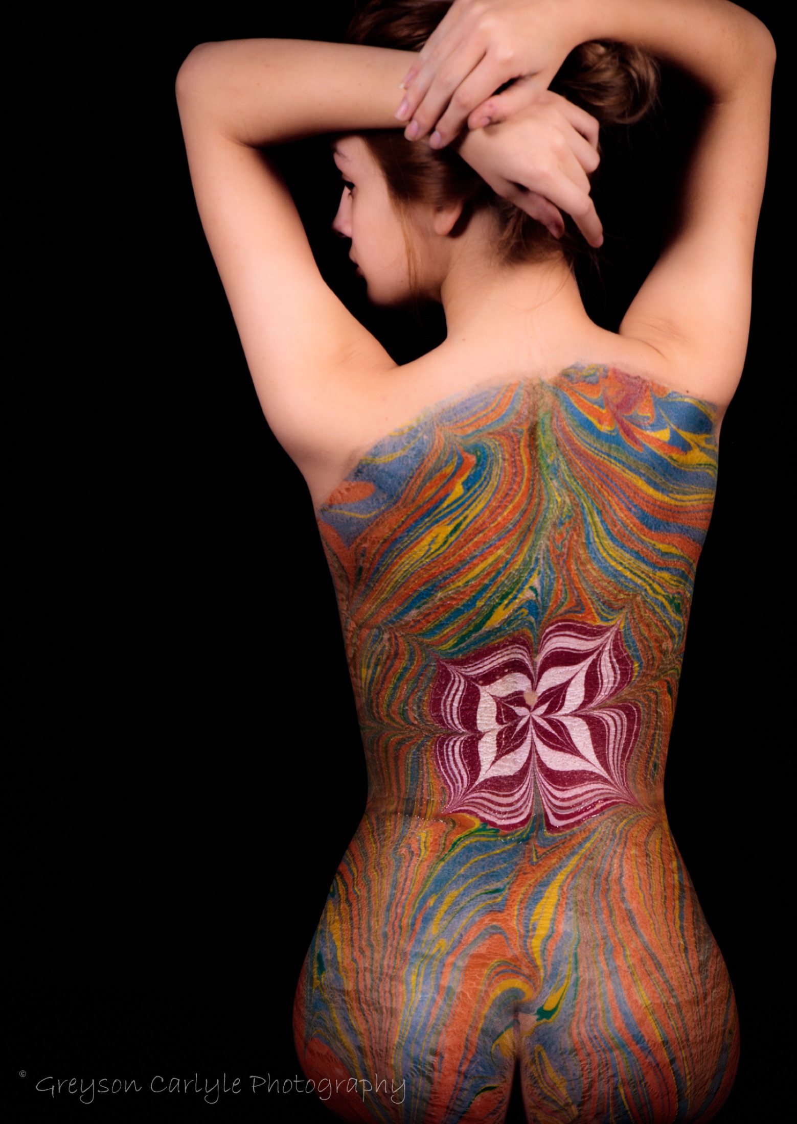 Back of a figure painted with an Ebru marbling pattern